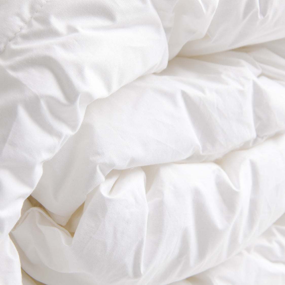 4-1 A folded beige duvet cover on a neutral background.