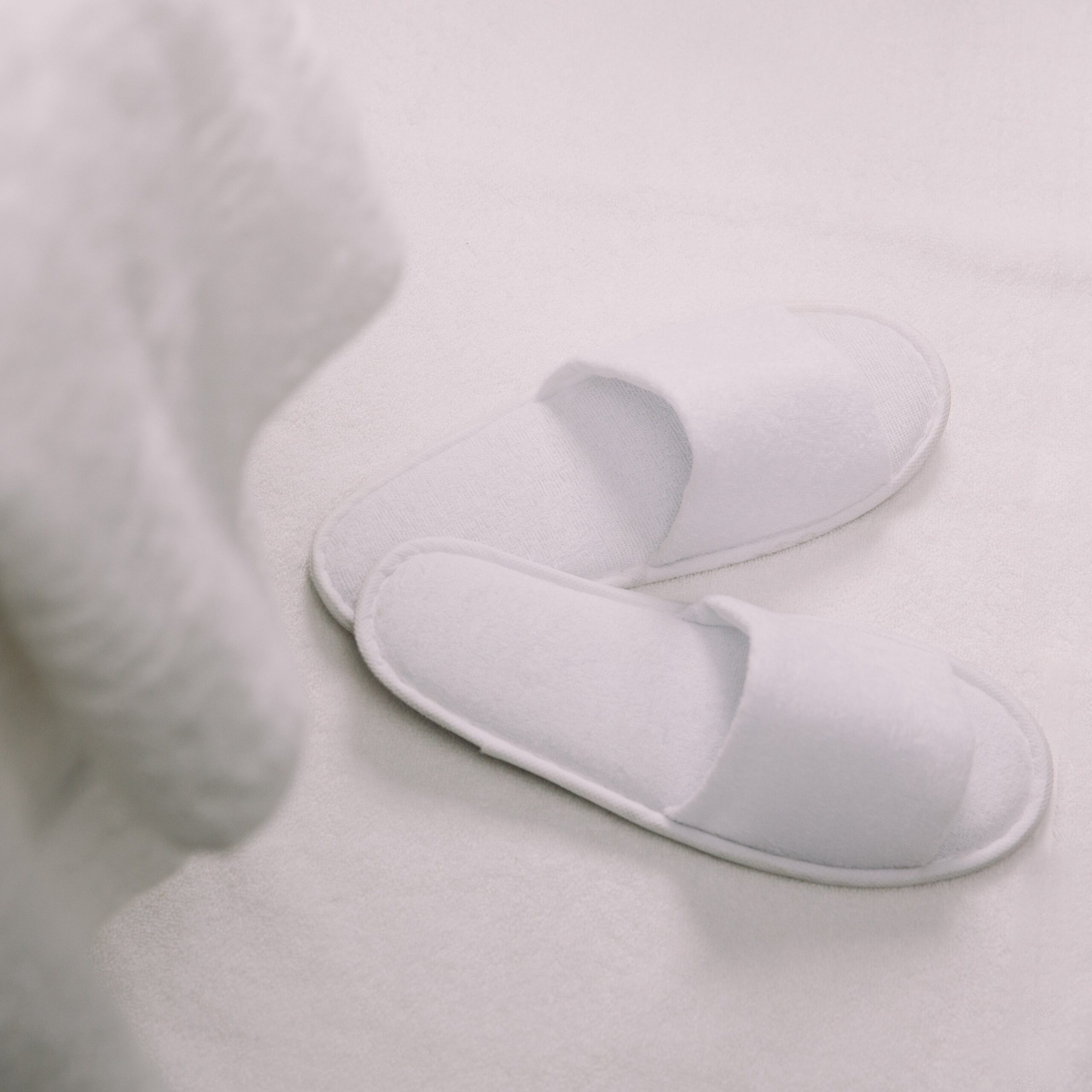 K1A0475-Edit White slippers on a white surface
