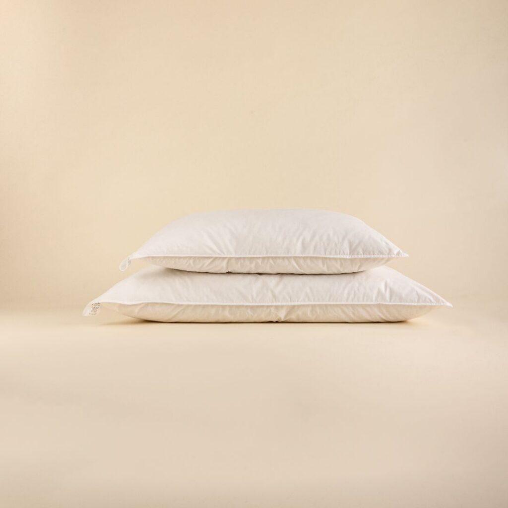 Two deluxe hypoallergenic microfiber pillows, one stacked on top of the other, placed against a neutral background.
